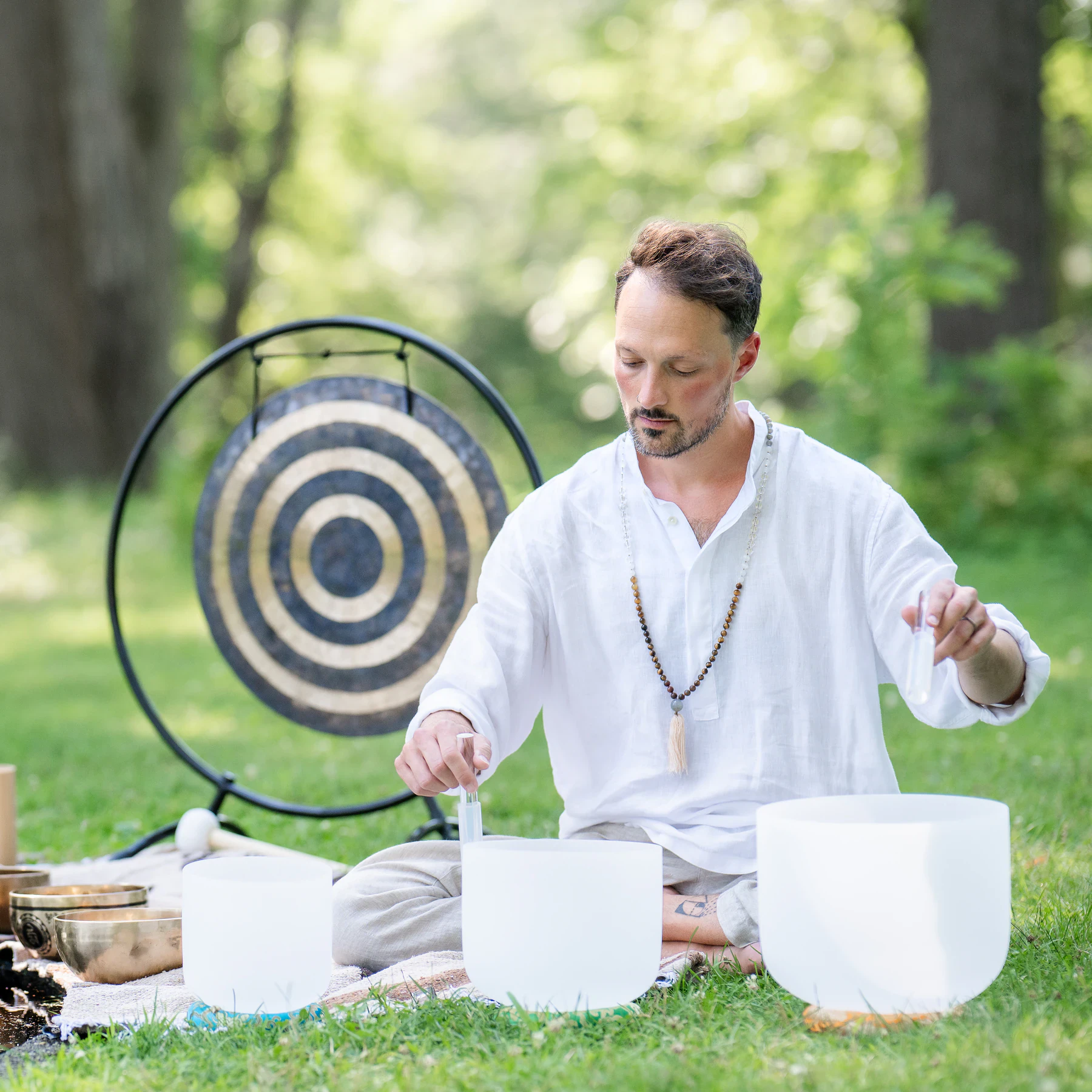 Matias playing crystal bowls outdoors